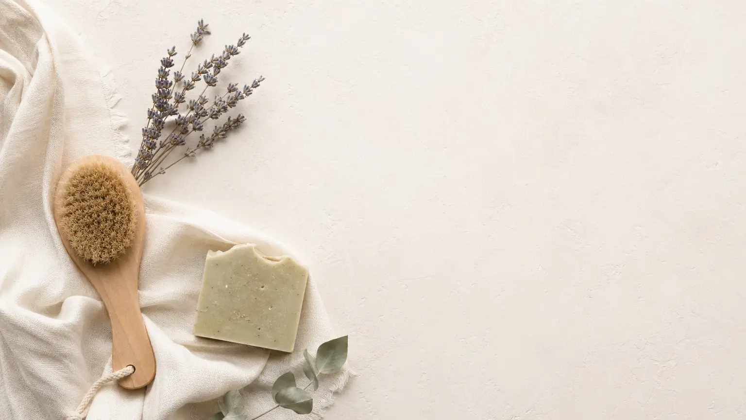 Organic living essentials arranged on a flatlay with linen, lavender, and handmade soap